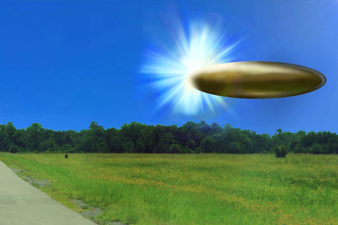 Saucer-shaped object with a bright light hovers over a grassy field.