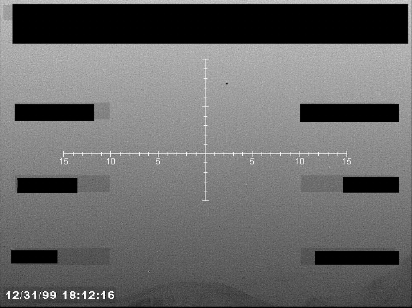 Redacted sensor image with a targeting reticle.